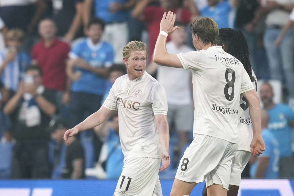 Napoli's Kevin De Bruyne celebrates with teammate Scott McTominay after scoring during the Italian Serie A soccer match between Sassuolo and Napoli at the Mapei Stadium Città del Tricolore in Reggio Emilia, Italy, Saturday, Aug. 23, 2025. (Massimo Paolone/LaPresse via AP)
