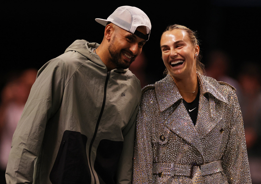 Aryna Sabalenka and Nick Kyrgios laugh ahead of their Battle of the Sexes tennis match in Dubai, United Arab Emirates, Sunday Dec. 28, 2025. (Amr Alfiky/Pool Photo via AP)