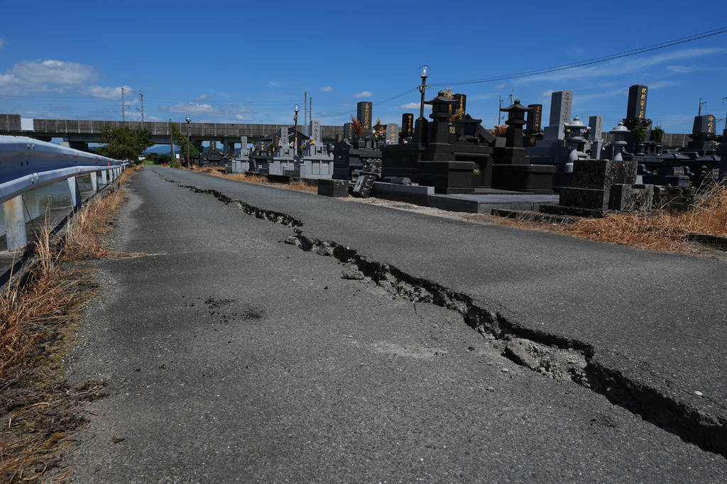 A street shows cracks in Uki, southern Japan, Friday, July 31, 2026, three days after an earthquake hit the area. (AP Photo/Hiro Komae)