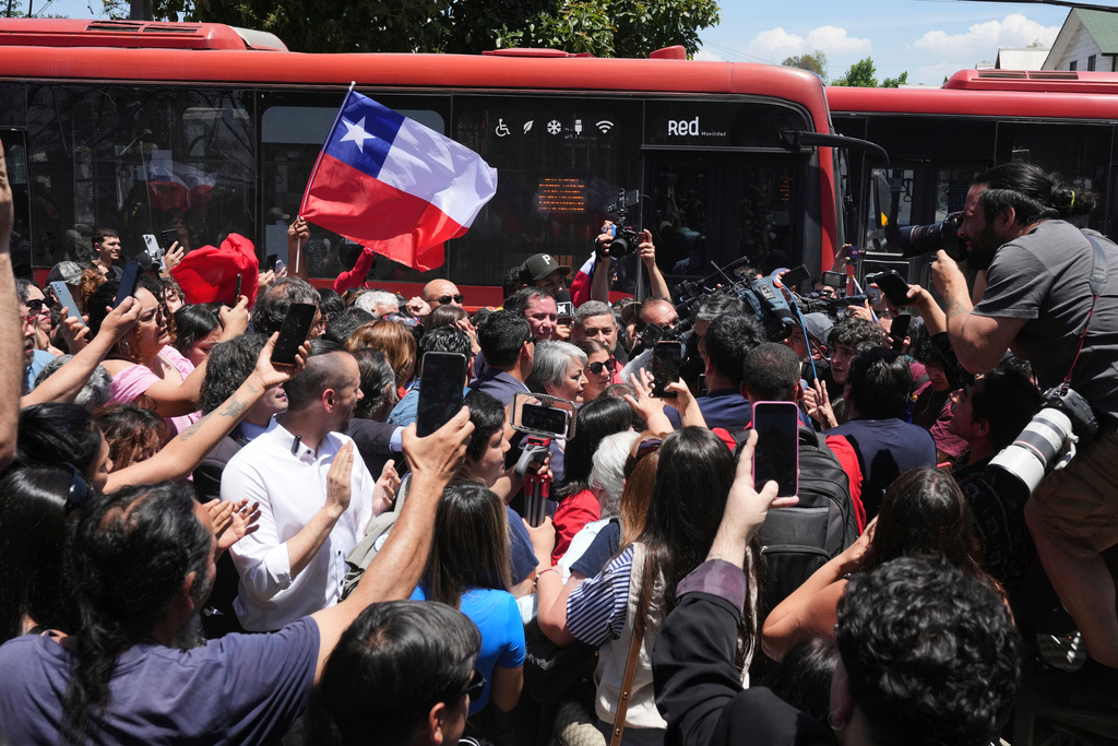 Presidential candidate Jeannette Jara of the Unidad por Chile coalition, center, arrives to vote at a polling station during general elections in Santiago, Chile, Sunday, Nov. 16, 2025. (AP Photo/Natacha Pisarenko)