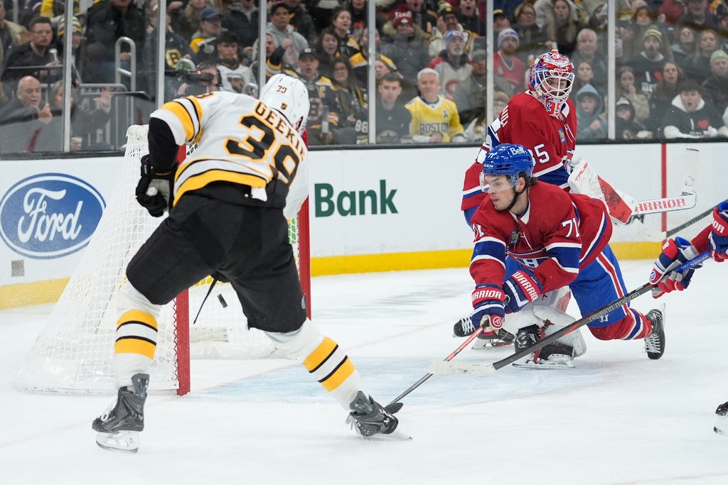 Boston Bruins center Morgan Geekie (39) scores a goal with Montreal Canadiens goaltender Samuel Montembeault (35) out of position in the second period of an NHL hockey game in Boston, Saturday, Jan. 24, 2026. (AP Photo/Robert F. Bukaty)