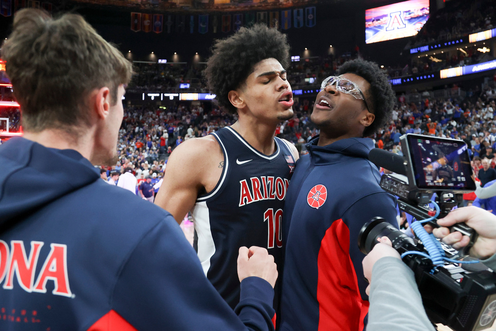 Arizona forward Koa Peat (10) and guard Bryce James (6) celebrate after their team's win against Florida during an NCAA college basketball game, Monday, Nov. 3, 2025, in Las Vegas. (AP Photo/Ian Maule)