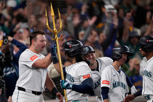 Seattle Mariners' Eugenio Suárez holds the trident after hitting a grand slam home run during the eighth inning in Game 5 of baseball's American League Championship Series against the Toronto Blue Jays, Friday, Oct. 17, 2025, in Seattle. (AP Photo/Lindsey Wasson) Seattle Mariners' Eugenio Suárez holds the trident after hitting a grand slam home run during the eighth inning in Game 5 of baseball's American League Championship Series against the Toronto Blue Jays, Friday, Oct. 17, 2025, in Seattle. (AP Photo/Lindsey Wasson)