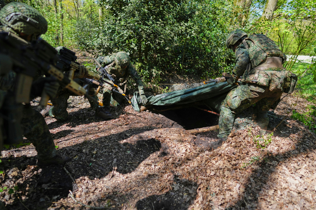 Members of the 10th Infantry Battalion Guard Security Corps National Reserve unearth an enemy foxhole during a weekend exercise to hone their military skills as the Netherlands beefs up its military with new recruits and volunteer reservists in Havelte, Netherlands, Saturday, April 25, 2026. (AP Photo/Peter Dejong)