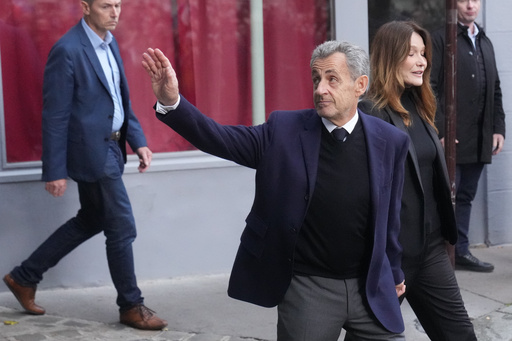 Former French President Nicolas Sarkozy and his wife Carla Bruni-Sarkozy leave their home Tuesday, Oct. 21, 2025 in Paris as Nicolas Sarkozy heads to prison to serve time for a criminal conspiracy to finance his 2007 election campaign with funds from Libya. (AP Photo/Thibault Camus) Former French President Nicolas Sarkozy and his wife Carla Bruni-Sarkozy leave their home Tuesday, Oct. 21, 2025 in Paris as Nicolas Sarkozy heads to prison to serve time for a criminal conspiracy to finance his 2007 election campaign with funds from Libya. (AP Photo/Thibault Camus)