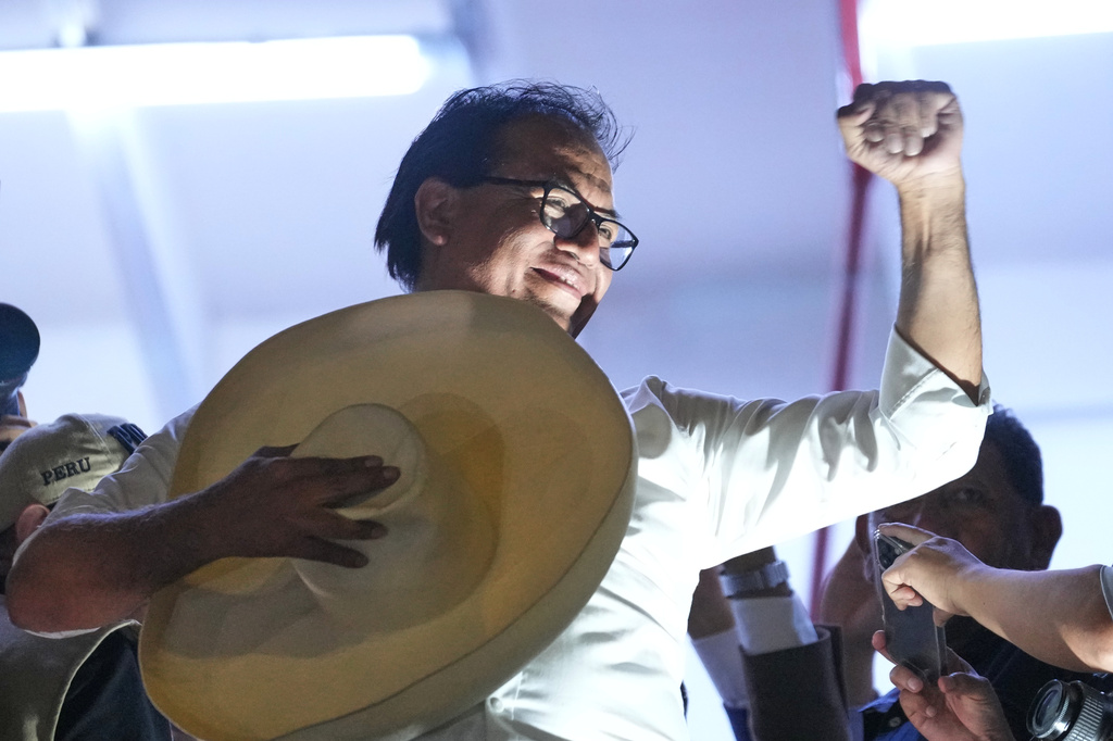 Presidential candidate Roberto Sanchez of the Together for Peru party appears on the balcony of his campaign headquarters after polls closed in the presidential runoff election in Lima, Peru, Sunday, June 7, 2026 (AP Photo/Rodrigo Abd)
