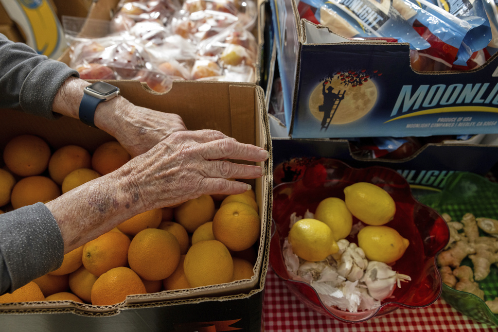 On Tuesdays, volunteers at Neighbor's Cupboard unload boxes of dry goods and sort fresh produce in Winterport, Maine, on Aug. 26, 2025. (Katherine Emery/The Maine Monitor via AP)