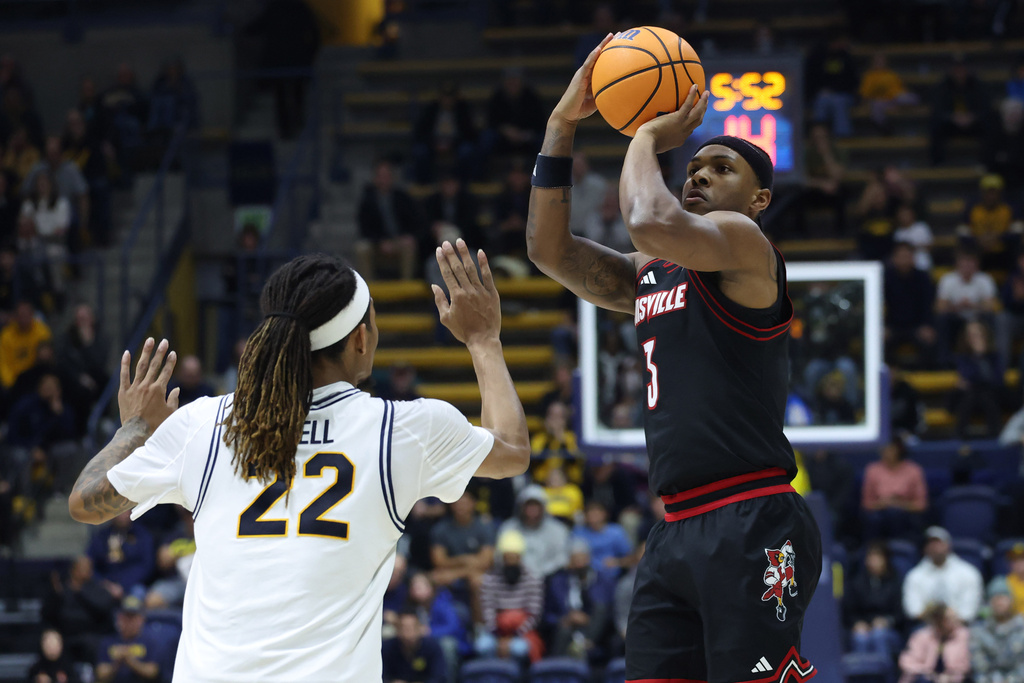 Louisville guard Ryan Conwell (3) shoots against California forward Chris Bell (22) during the second half of an NCAA college basketball game in Berkeley, Calif., Saturday, Dec. 30, 2025. (AP Photo/Jed Jacobsohn)