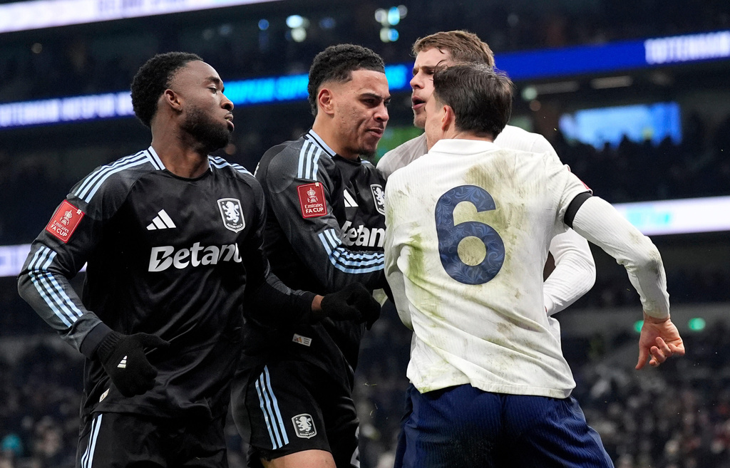 Aston Villa's Morgan Rogers, second left, and Tottenham Hotspur's Joao Palhinha, right, clash after the FA Cup third round soccer match between Tottenham Hotspur and Aston Villa in London, Saturday Jan. 10, 2026. (Andrew Matthews/PA via AP)