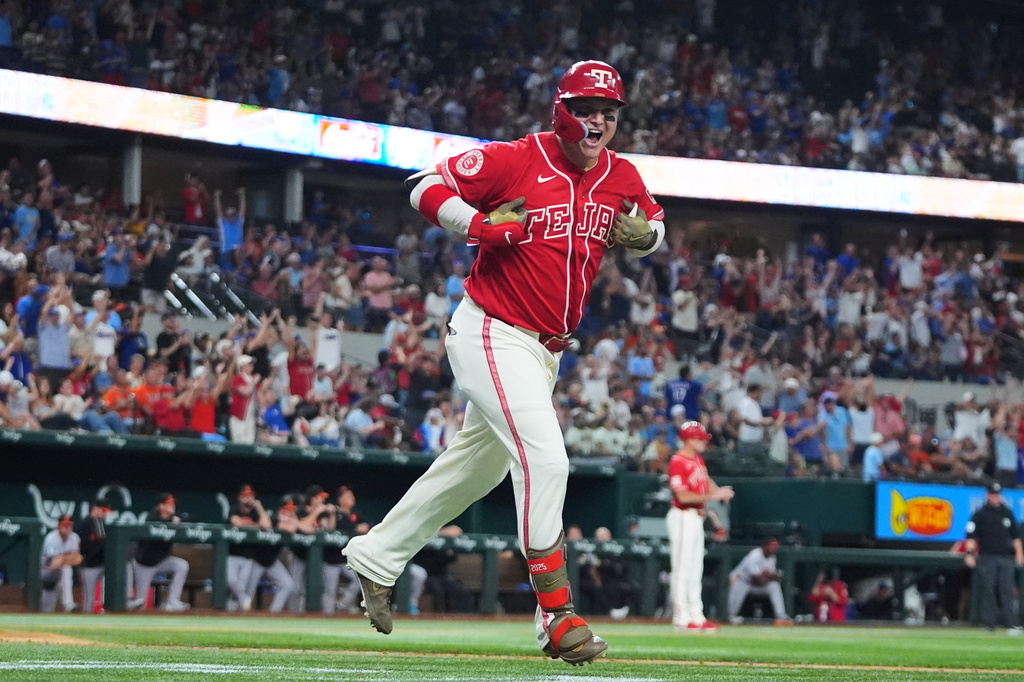 Texas Rangers designated hitter Joc Pederson celebrates after his two-run home run that also scored Elias Díaz during the sixth inning of a baseball game against the Baltimore Orioles, Friday, Aug. 7, 2026, in Arlington, Texas. (AP Photo/LM Otero)