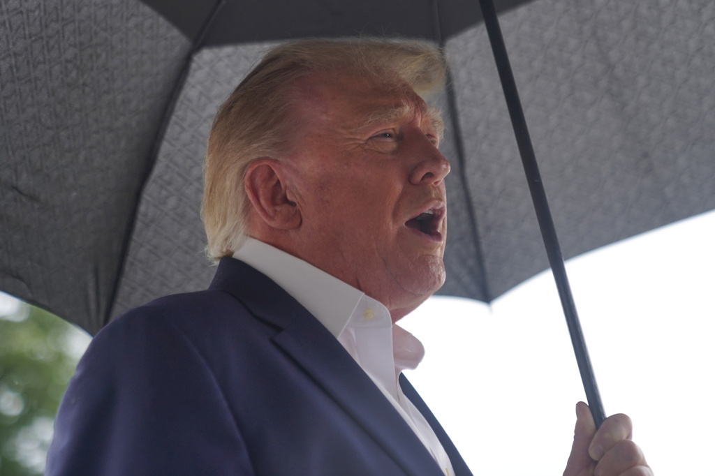 President Donald Trump talks to reporters on the South Lawn of the White House before boarding Marine One, Sunday, Sept. 27, 2026, in Washington. (AP Photo/Allison Robbert)