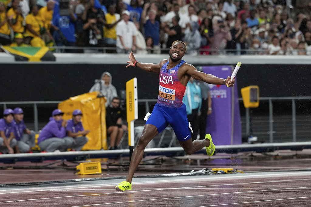 United States' Noah Lyles crosses the finish line to win the men's 4 X 100 meters relay at the World Athletics Championships in Tokyo, Sunday, Sept. 21, 2025. (AP Photo/Matthias Schrader)