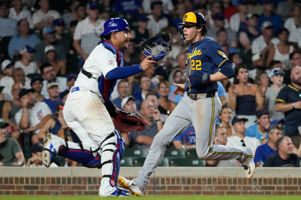 Milwaukee Brewers' Christian Yelich, right, scores on a one-run single by Cooper Pratt as Chicago Cubs catcher Miguel Amaya waits for the ball during the seventh inning of a baseball game in Chicago, Wednesday, Sept. 2, 2026. (AP Photo/Nam Y. Huh)