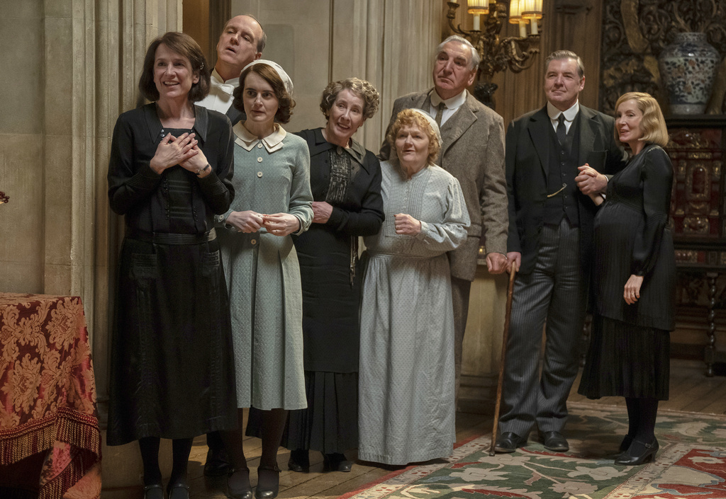 This image released by Focus Features shows Raquel Cassidy, from left, Kevin Doyle, Sophie McShera, Phyllis Logan, Lesley Nicol, Jim Carter, Brendan Coyle and Joanne Froggatt in a scene from "Downton Abbey: The Grand Finale." (Focus Feature via AP)