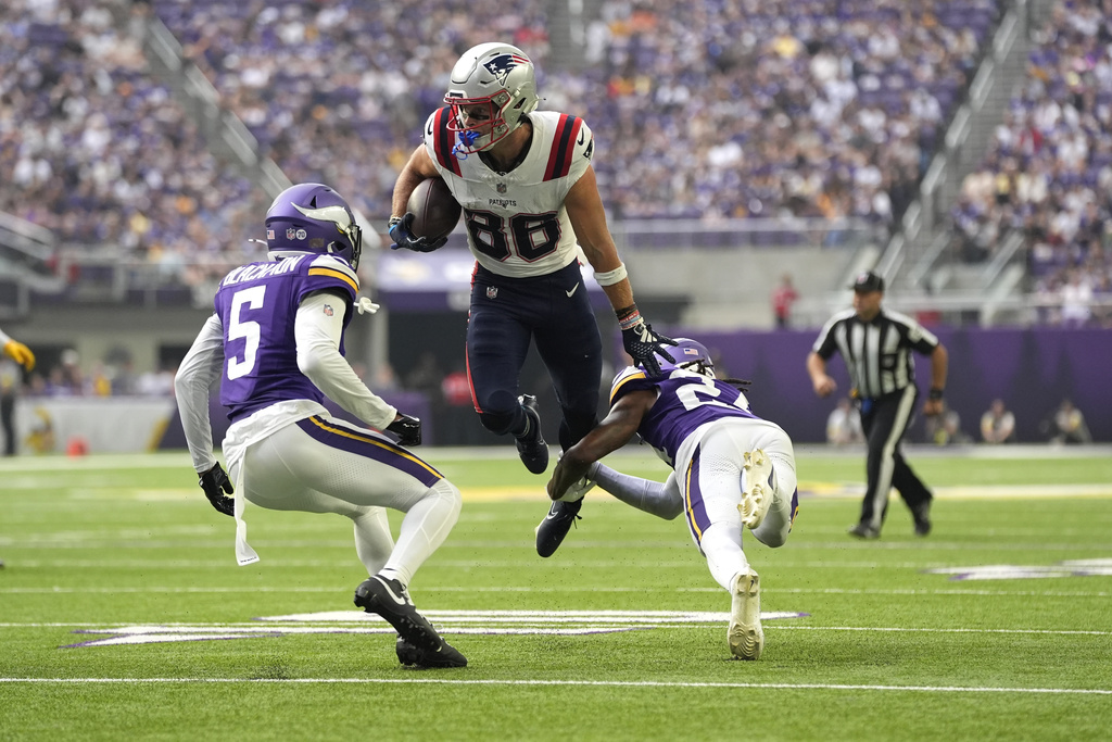 New England Patriots wide receiver Efton Chism III (86) avoids a tackle from Minnesota Vikings safety Jay Ward, right, and cornerback Mekhi Blackmon (5) to score a touchdown during the first half of a preseason NFL football game Saturday, Aug. 16, 2025, in Minneapolis. (AP Photo/Abbie Parr)