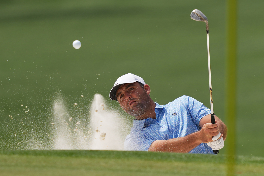 Scottie Scheffler hits from the bunker on the sixth hole during a practice round ahead of the Masters golf tournament at the Augusta National Golf Club, Tuesday, April 7, 2026, in Augusta, Ga. (AP Photo/Matt Slocum)