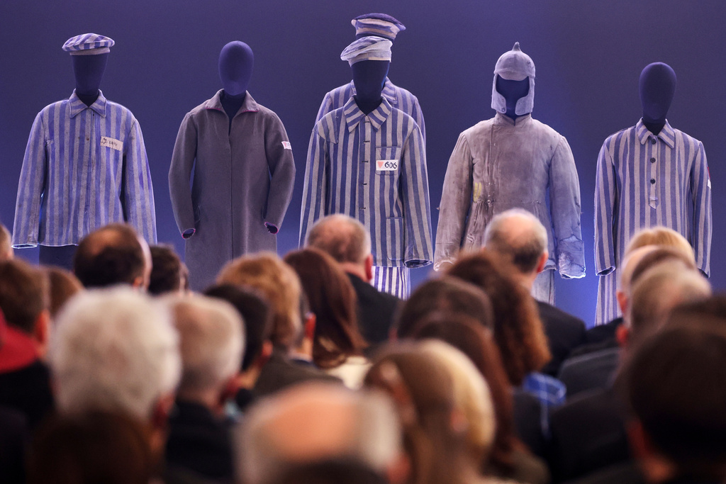 People attend a ceremony marking the 81th anniversary of the camp's liberation in the Auschwitz Nazi death camp museum in Oswiecim, Poland, Tuesday, Jan. 27, 2026. (AP Photo/Beata Zawrzel)