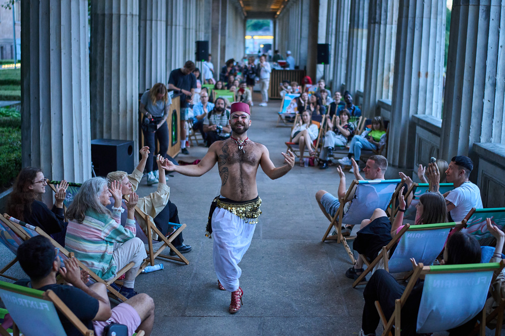Haidar Darwish, a Syrian belly dancer with the Berlin-based LGBTQ collective Queens Against Borders, performs during an open-air show in Berlin, Germany, Sunday, July 26, 2026. (AP Photo/Ebrahim Noroozi)