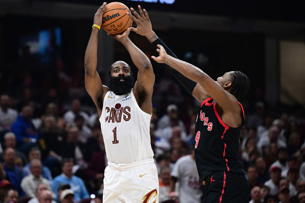 Cleveland Cavaliers guard James Harden shoots a three point shot over Toronto Raptors forward RJ Barrett during the second half in Game 5 of a first-round NBA playoffs basketball series, Wednesday, April 29, 2026, In Cleveland. (AP Photo/David Dermer)