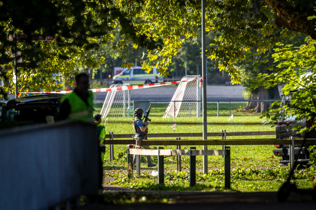 Armed police officers patrol near the Schachen horse racing track in Aarau following a shooting during a rave event near Aarau, Switzerland, Sunday, Aug. 30, 2026. (Michael Buholzer/Keystone via AP)