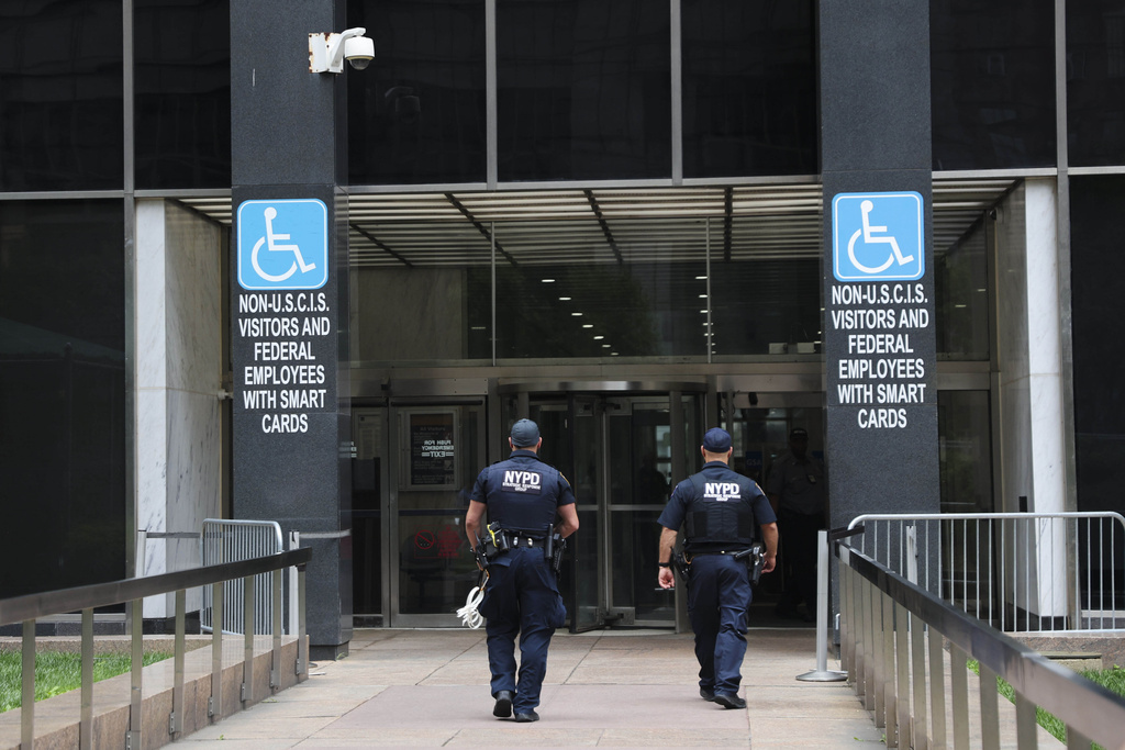 FILE - Members of the NYPD Strategic Response Group enter 26 Federal Plaza, where immigration court is located, June 8, 2025, in New York. (AP Photo/Heather Khalifa, File)
