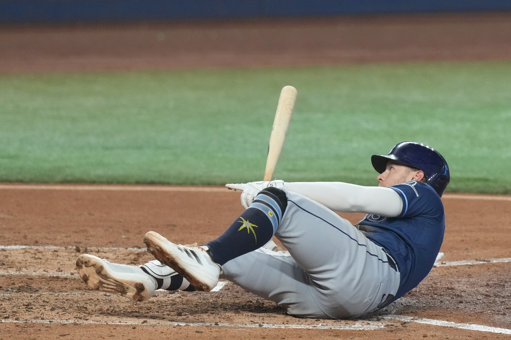 Tampa Bay Rays Taylor Walls signals to the home plate umpire after he was hit by a pitch during the fifth inning of a baseball game against the Miami Marlins Sunday, June 7, 2026, in Miami. (AP Photo/Marta Lavandier)
