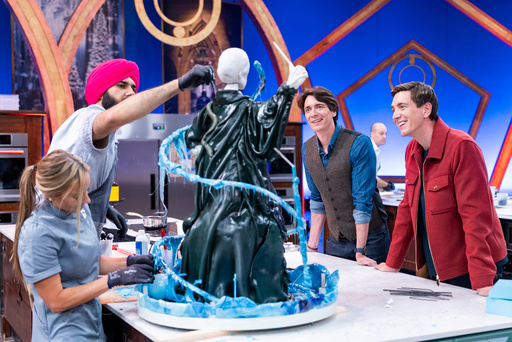 This image released by Food Network shows hosts Oliver Phelps, right, and James Phelps, watching contestants Katie Bonzer, left, and Jujhar Mann on the set of the competition series "Harry Potter: Wizards of Baking." (Anders Krusberg/Food Network via AP) This image released by Food Network shows hosts Oliver Phelps, right, and James Phelps, watching contestants Katie Bonzer, left, and Jujhar Mann on the set of the competition series "Harry Potter: Wizards of Baking." (Anders Krusberg/Food Network via AP)