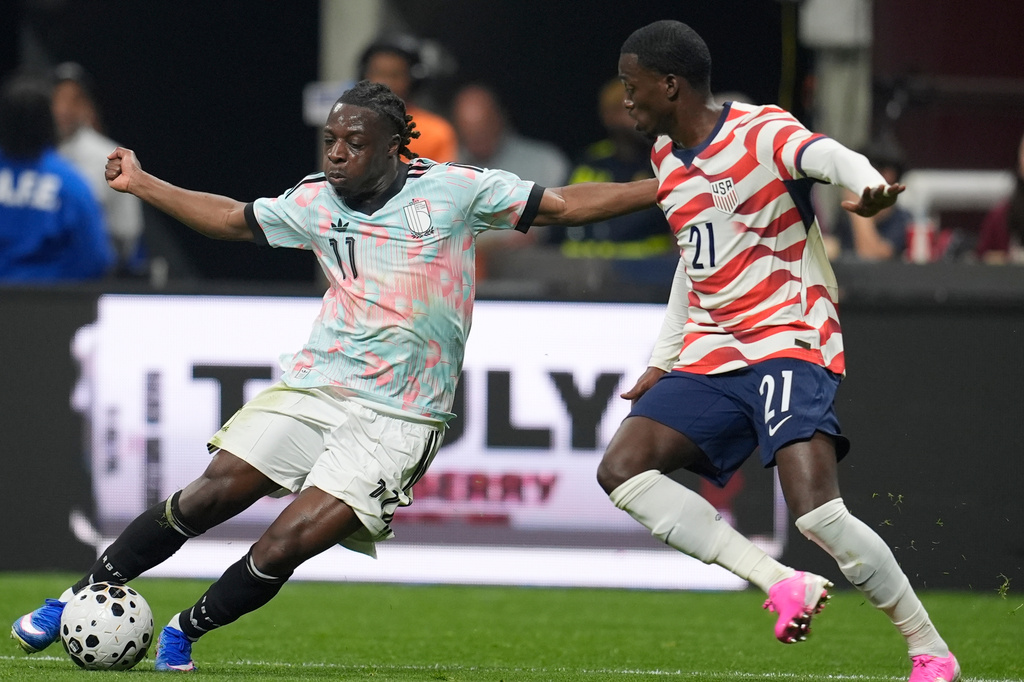 Belgium's Jeremy Doku moves against the United States' Timothy Weah (21) during an international friendly soccer match, Saturday, March 28, 2026, in Atlanta. (AP Photo/Mike Stewart)