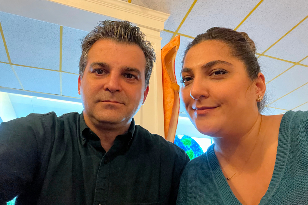 Kaveh Javanshirjavid, left, and his wife, Mina Rezaei, who are in limbo amidst a pause on visa applications for people from over three dozen countries, including Iran, pose for a photo Thursday, May 7, 2026, in Edwardsville, Ill. (Kaveh Javanshirjavid via AP)