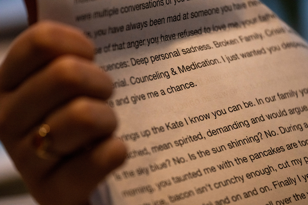 Kate goes through folders of writings and photographs from her time at Unita Academy and other residential programs in her apartment in Kentucky, Wednesday, Dec. 10, 2025. (AP Photo/Michael Swensen)