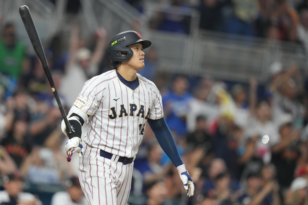 Japan's Shohei Ohtani hits a single home run during the first inning against Venezuela of a World Baseball Classic quarterfinal game, Saturday, March 14, 2026, in Miami. (AP Photo/Lynne Sladky)
