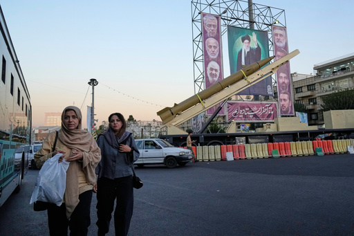 People walk past a domestically-built missile "Khaibar-buster," and banners showing portraits of the Iranian Supreme Leader Ayatollah Ali Khamenei, center, and the late armed forces commanders, who were killed in Israeli strike in June, displayed in a military exhibition commemorating the anniversary of the start of the 1980-88 Iraq-Iran war, and 12-day war with Israel in June, at Baharestan Square in Tehran, Thursday, Sept. 25, 2025. (AP Photo/Vahid Salemi) People walk past a domestically-built missile "Khaibar-buster," and banners showing portraits of the Iranian Supreme Leader Ayatollah Ali Khamenei, center, and the late armed forces commanders, who were killed in Israeli strike in June, displayed in a military exhibition commemorating the anniversary of the start of the 1980-88 Iraq-Iran war, and 12-day war with Israel in June, at Baharestan Square in Tehran, Thursday, Sept. 25, 2025. (AP Photo/Vahid Salemi)