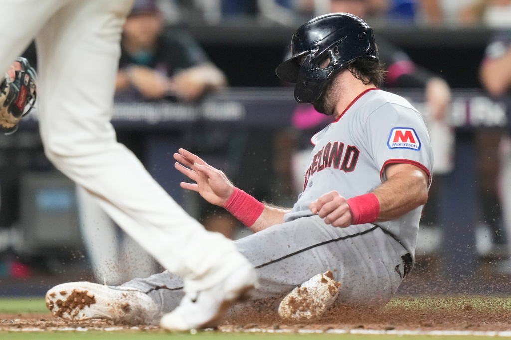 Cleveland Guardians' Austin Hedges scores on a sacrifice fly hit by Travis Bazzana during the fifth inning of a baseball game against the Miami Marlins, Friday, July 10, 2026, in Miami. (AP Photo/Lynne Sladky)