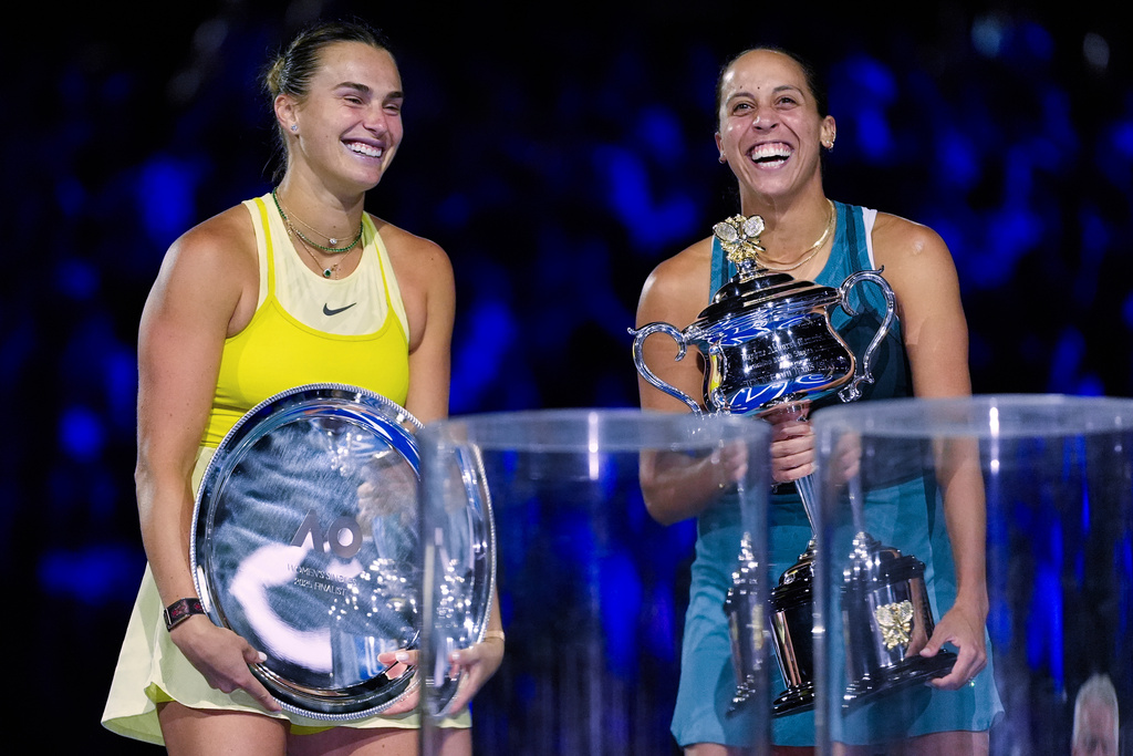 FILE -Madison Keys, right, of the U.S. reacts as she holds the Daphne Akhurst Memorial Cup after defeating Aryna Sabalenka, left, of Belarus in the women's singles final at the Australian Open tennis championship in Melbourne, Australia, Jan. 25, 2025. (AP Photo/Asanka Brendon Ratnayake, File)