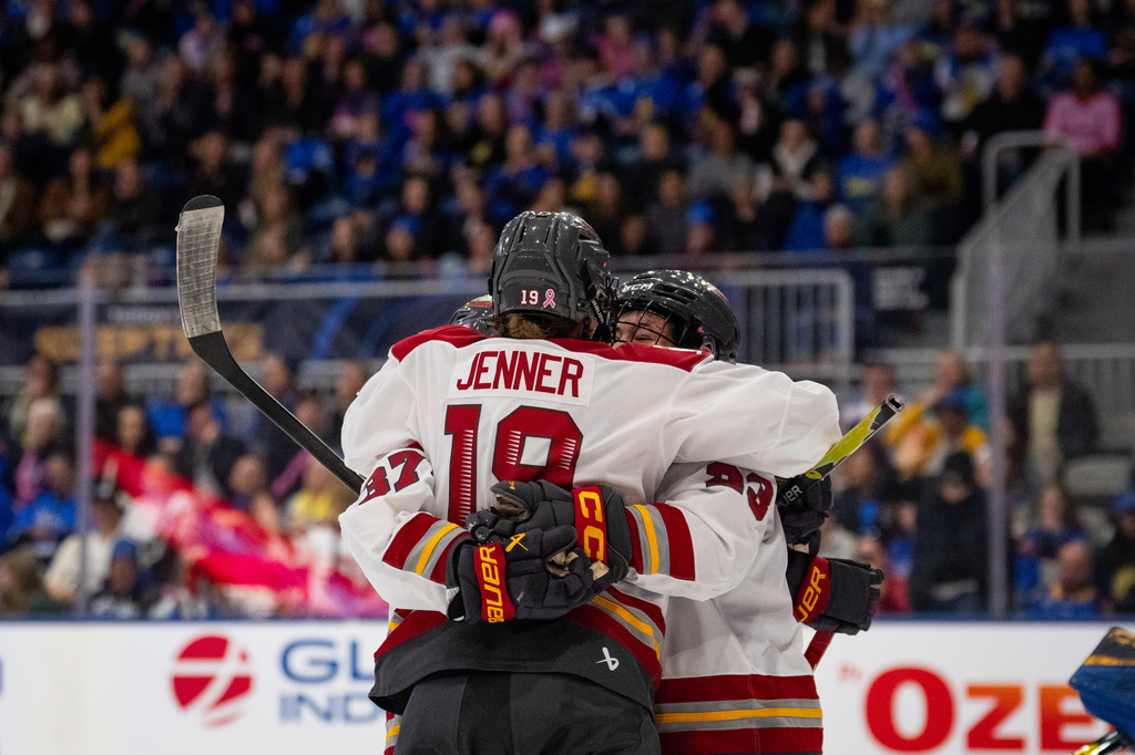 Ottawa Charge forward Brianne Jenner (19) celebrates with teammates after her goal against Toronto Sceptres goaltender Raygan Kirk during third-period PWHL hockey game action in Toronto, Saturday, April 11, 2026. (Arlyn McAdorey/The Canadian Press via AP)