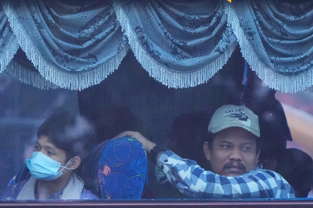Myanmar nationals look out from a bus in Manjung, Perak state of Malaysia, on Tuesday, Sept. 29, 2026. (AP Photo/Vincent Thian)