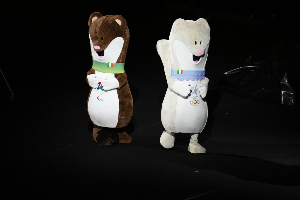 Tina and Milo, Olympics and Paralympics mascots, dance before the Olympic opening ceremony at the 2026 Winter Olympics, in Milan, Italy, Friday, Feb. 6, 2026. (AP Photo/Ben Curtis)