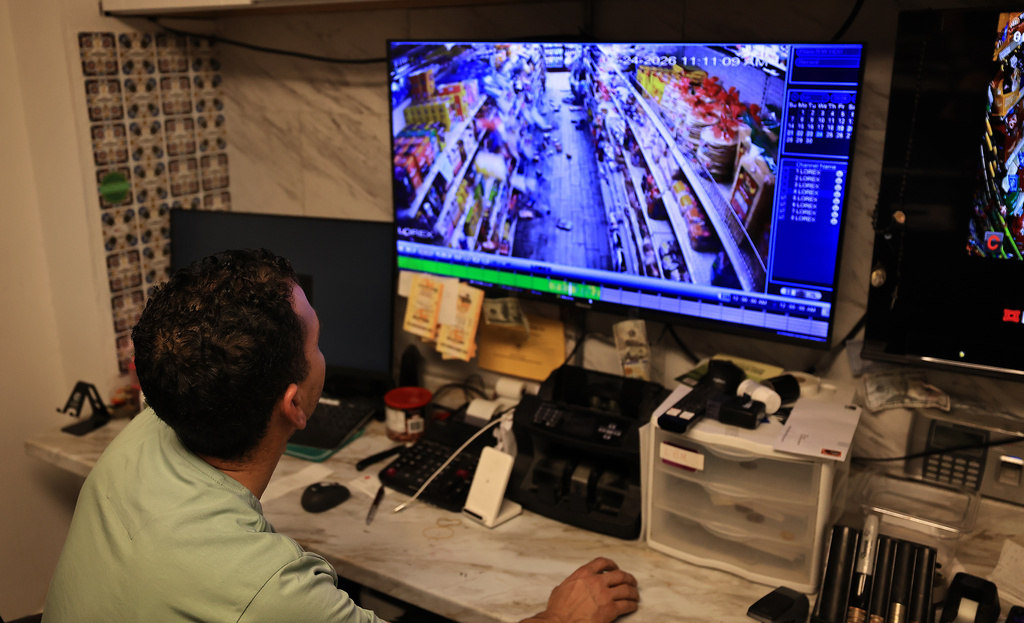 Redwood Valley Market owner Alex Chehada watches his closed circuit feed showing the time when an earthquake struck in Redwood Valley, Calif., Wednesday, June 24, 2026. (Kent Porter/The Press Democrat via AP)