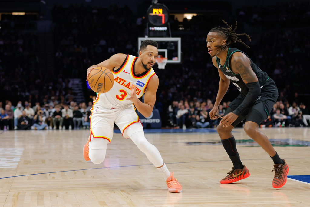 Atlanta Hawks guard CJ McCollum, left, drives while Minnesota Timberwolves guard Ayo Dosunmu, right, defends during the first half of an NBA basketball game, Monday, Feb. 9, 2026, in Minneapolis. (AP Photo/Bailey Hillesheim)