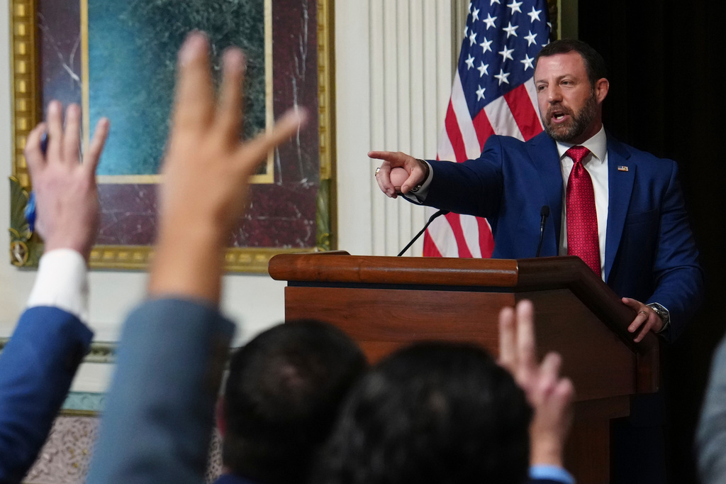 Reporters raise their hands as Homeland Security Secretary Markwayne Mullin speaks in the Indian Treaty Room at the Eisenhower Executive Office Building on the White House campus, Friday, July 17, 2026, in Washington. (AP Photo/Julia Demaree Nikhinson)