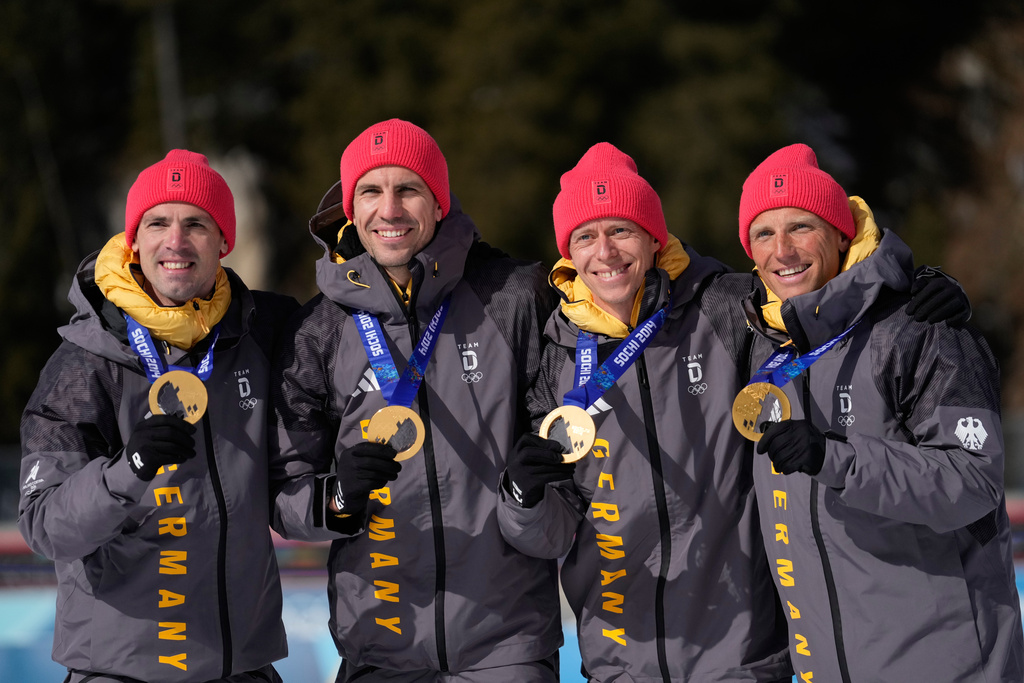 Germany's Erik Lesser, Daniel Boehm, Arnd Peiffer and Simon Schempp, pose with the gold medal for the men's 4x7.5-kilometer biathlon relay race from the 2014 Sochi Winter Olympics during a reallocation medals ceremony at the 2026 Winter Olympics in Anterselva, Italy, Sunday, Feb. 15, 2026. (AP Photo/Mosa'ab Elshamy)