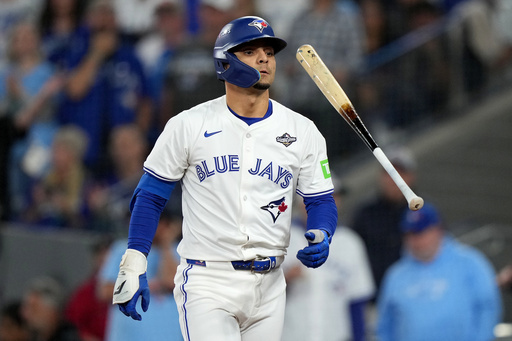 Toronto Blue Jays' Andrés Giménez (0) flips his bat after striking out against the Los Angeles Dodgers during the eighth inning in Game 2 of baseball's World Series, Saturday, Oct. 25, 2025, in Toronto. (Nathan Denette/The Canadian Press via AP) Toronto Blue Jays' Andrés Giménez (0) flips his bat after striking out against the Los Angeles Dodgers during the eighth inning in Game 2 of baseball's World Series, Saturday, Oct. 25, 2025, in Toronto. (Nathan Denette/The Canadian Press via AP)