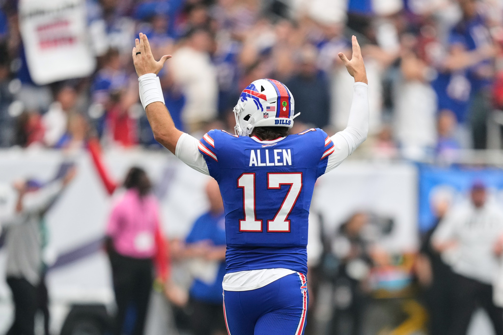 Buffalo Bills quarterback Josh Allen (17) reacts after wide receiver DJ Moore scored a touchdown during the first half of an NFL football game against the Houston Texans, Sunday, Sept. 13, 2026, in Houston. (AP Photo/Ashley Landis)