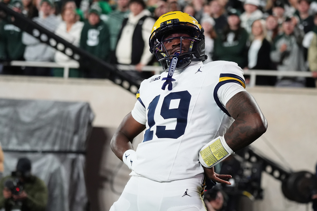 Michigan quarterback Bryce Underwood celebrates after scoring a touchdown during the first half of an NCAA college football game against Michigan State Saturday, Oct. 25, 2025, in East Lansing, Mich. (AP Photo/Ryan Sun)