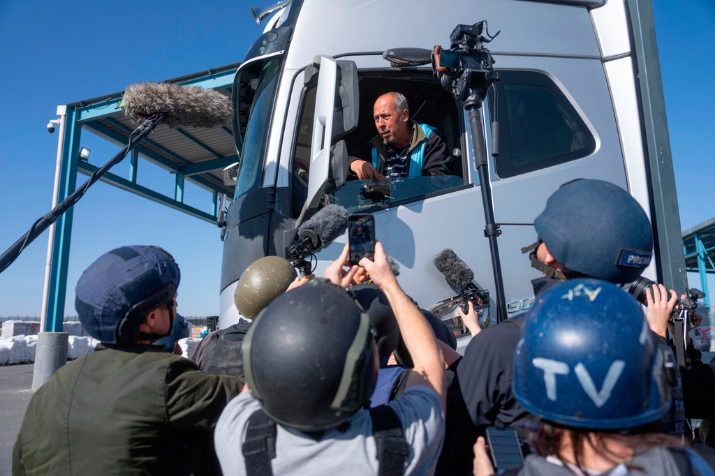 FILE - A truck driver picks up humanitarian aid designated for Gaza, as reporters tour the Palestinian side of the Kerem Shalom crossing where aid is awaiting pickup, on Dec. 19, 2024. (AP Photo/Ohad Zwigenberg, File)