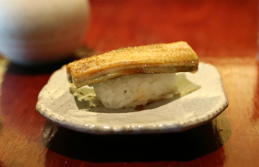 FILE - In this Thursday, July 20, 2017 photo, a dish of eel nigiri is served at Miyake, a Japanese restaurant, in Portland, Maine. (AP Photo/Robert F. Bukaty, File)