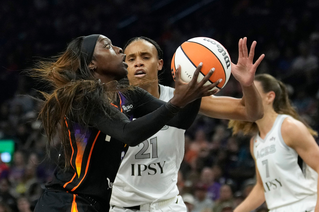 Phoenix Mercury guard-forward Kahleah Copper, left, drives to the basket against Las Vegas Aces forward-center Brianna Turner (21) during the first half of a WNBA basketball game, in Phoenix, Thursday, Sept. 24, 2026. (AP Photo/Ross D. Franklin)