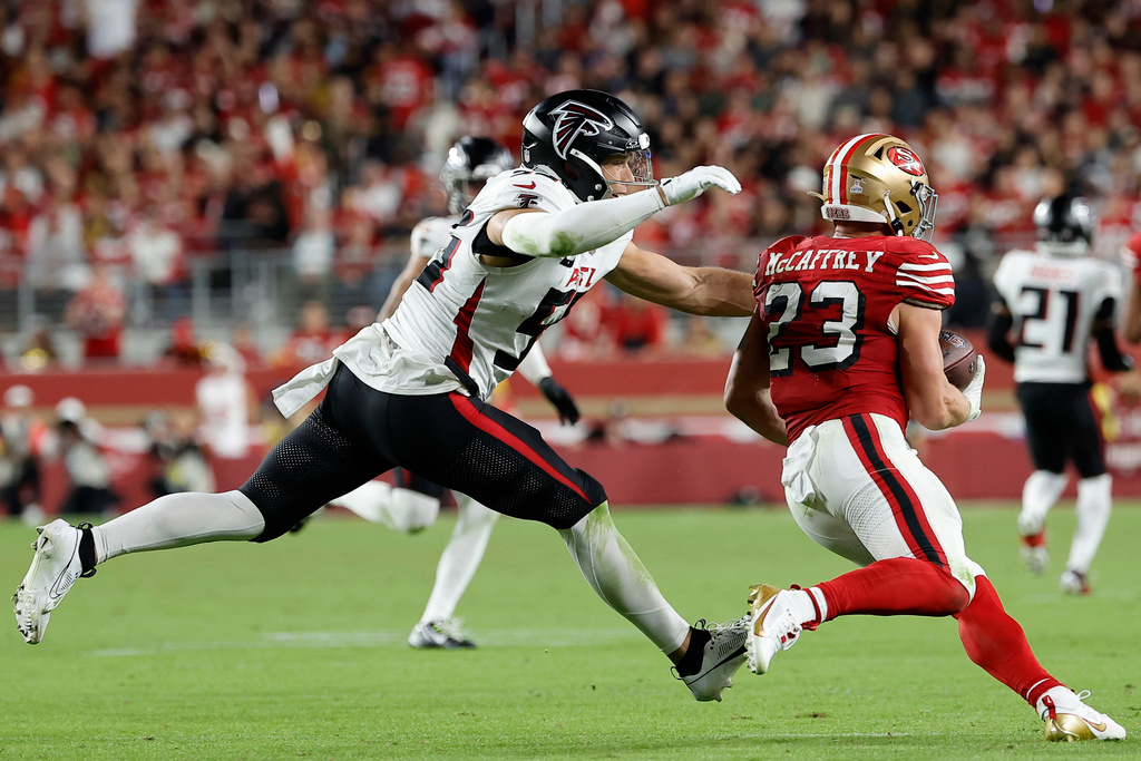 San Francisco 49ers running back Christian McCaffrey (23) runs against Atlanta Falcons linebacker Kaden Elliss (55) in the second half of an NFL football game, Sunday, Oct. 19, 2025, in Santa Clara, Calif. (AP Photo/Kelley L Cox)