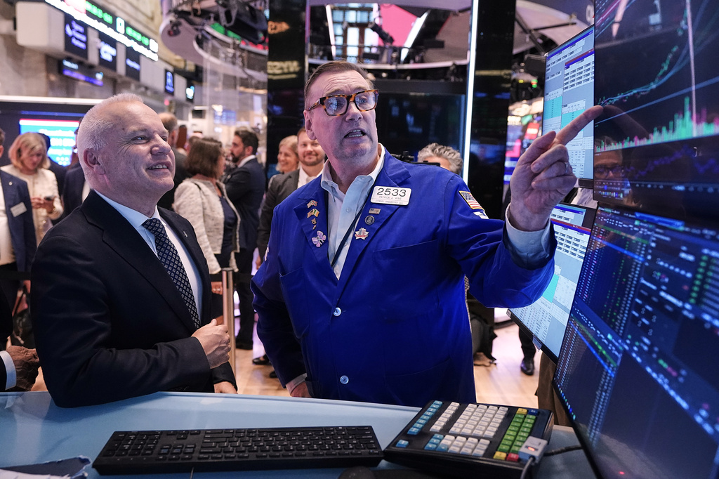 Anders Opedal, President and CEO of Norway's Equinor, left, meets with specialist Patrick King on the floor of the New York Stock Exchange, after he rang the closing bell, Tuesday, June 16, 2026. (AP Photo/Richard Drew)
