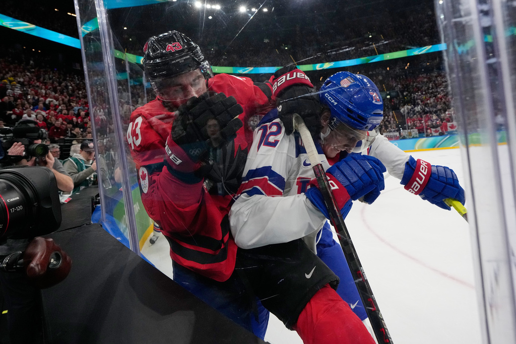 Canada's Tom Wilson (43) and United States' Tage Thompson (72) battle for the puck during the second period of a men's ice hockey gold medal game between Canada and the United States at the 2026 Winter Olympics, in Milan, Italy, Sunday, Feb. 22, 2026. (AP Photo/Petr David Josek)